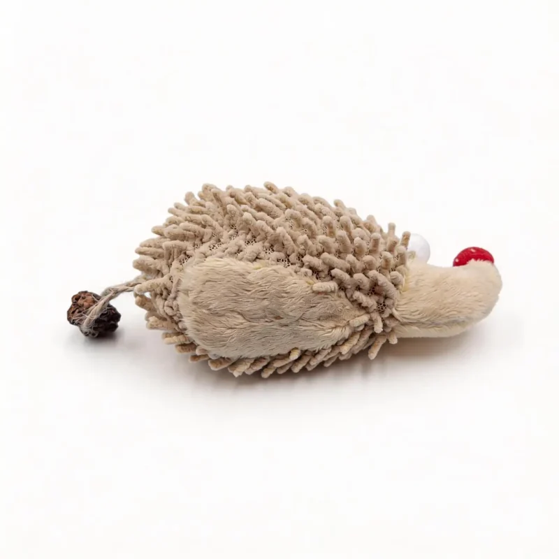 Chenille Hedgehog Cat Kicker Toy lying on a white background, with beige looped chenille plush, a red nose, soft eyes, and a silvervine fruit tail for cats to bat, bite, and kick.