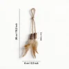 Silvervine Feather Hang and Play Interactive Cat Chew Toy size chart showing a hanging rope loop, two silvervine sticks, natural feathers, 26 cm (10.2 in) length, and 6 cm (2.3 in) width.