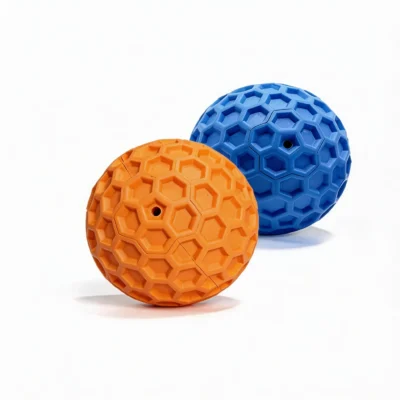 Honeycomb Squeaky Dog Fetch Ball Blue and Orange Set Honeycomb Squeaky Dog Fetch Ball set in blue and orange, showing textured rubber balls with squeaker holes on a white background.