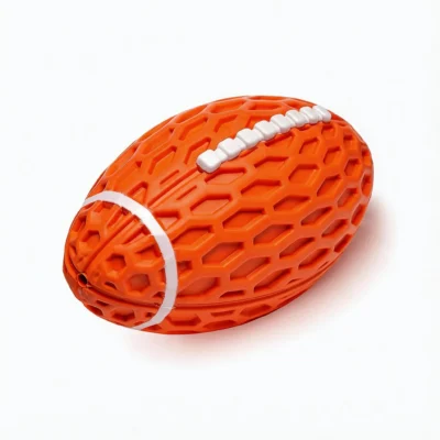 Orange Honeycomb Squeaky Football Dog Toy Close-Up Orange Honeycomb Squeaky Football Dog Toy close-up with raised honeycomb texture, white football lacing, and a chew-friendly rubber design.