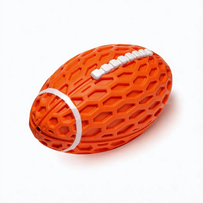 Orange Honeycomb Squeaky Football Dog Toy Close-Up Orange Honeycomb Squeaky Football Dog Toy close-up with raised honeycomb texture, white football lacing, and a chew-friendly rubber design.