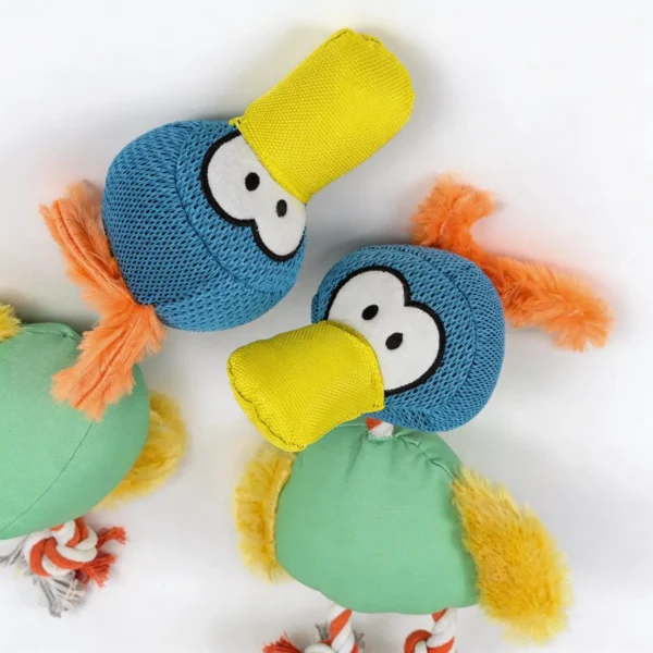 Close-up of the ToucanTuff Tug & Chew Plush Rope Dog Toy with blue mesh toucan heads, yellow canvas beaks, and orange plush tufts.