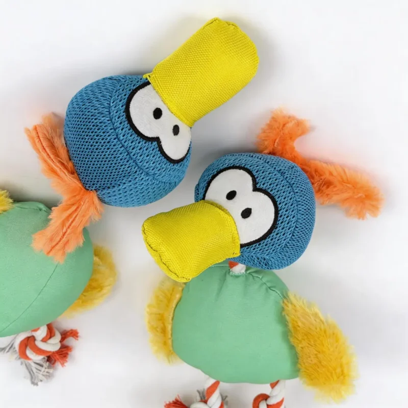 ToucanTuff Tug Chew Plush Rope Dog Toy Closeup Close-up of the ToucanTuff Tug & Chew Plush Rope Dog Toy with blue mesh toucan heads, yellow canvas beaks, and orange plush tufts.
