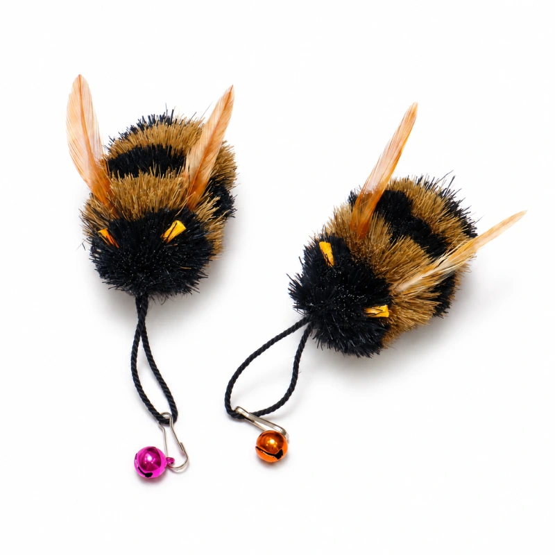 black-yellow-bumble-bee-cat-teaser-toy-fluffy-insect-lure Black and yellow bumble bee insect cat toy with fluffy body, feather wings, and bell attachment designed as a cat hunting toy replacement.
