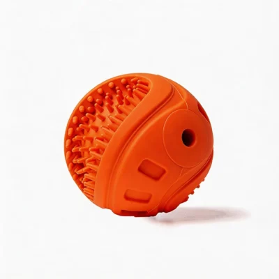 BriteBite Squeaky Textured Rubber Dog Chew Ball Orange Close-Up BriteBite Squeaky Textured Rubber Dog Chew Ball close-up with orange textured rubber, deep-clean bristles, side hole, and raised chew details.