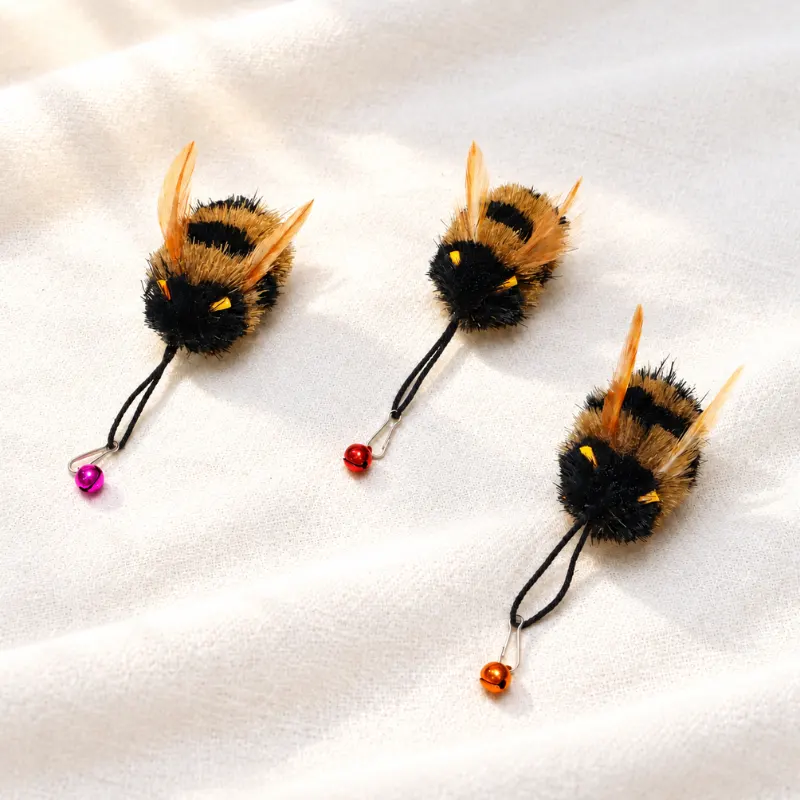 bumble-bee-cat-teaser-toy-natural-flying-prey-play-scene Handmade bumble bee cat teaser toy with fluffy body and fluttering wings shown in a natural outdoor scene for playful hunting style interaction.