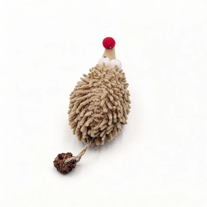 Top view of the Chenille Hedgehog Cat Kicker Toy showing the textured beige chenille body, red plush nose, round eyes, and silvervine fruit attached by a short rope.