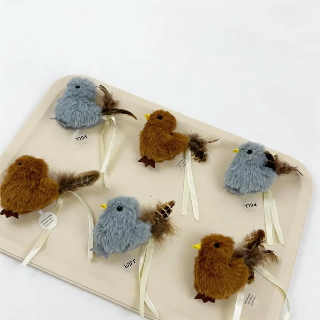 Misty Sparrow and Cinnamon Finch Chirpy Bird Tap-Activated Plush Cat Toy set with fluffy bodies, feather tails, pull tags, and ribbon loops.