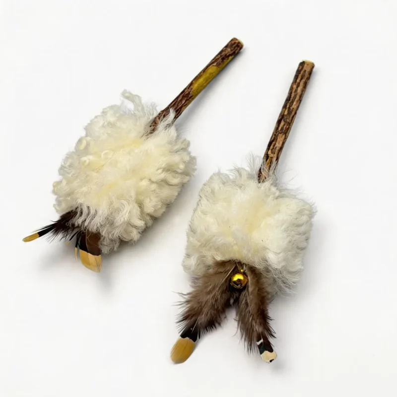 Cream Wool Fur Silvervine Kick Stick for Cats Two Cream Wool Fur Silvervine Kick Sticks with curly wool texture, natural feather accents, small bells, and matatabi wood chew handles for cat enrichment.