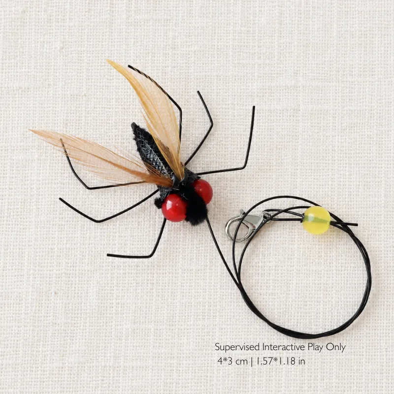 Fly insect cat toy feather wand featuring black insect legs, red eyes, and lightweight feather wings for interactive hunting play.