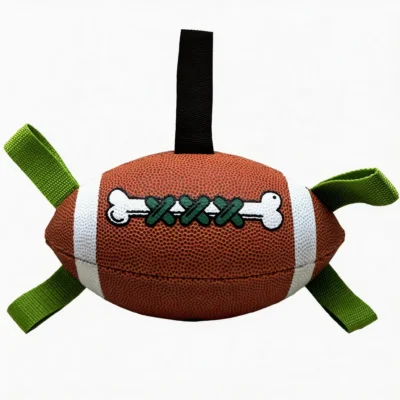 Inflatable Floating Football Tug Dog Toy close-up showing a brown football design with green grab tabs, black handle, textured surface, and bone lace detail.