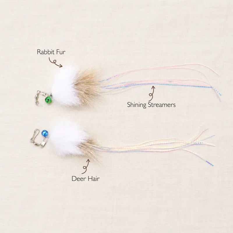 jellyfish-rabbit-fur-wand-toy-materials Two Jellyfish Rabit Fur wand toys for kittens showing white rabbit fur, deer hair, colored bells, and long iridescent ribbon-like streamers.