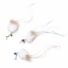 jellyfish-wand-cat-toys-colored-bells Three jellyfish wand cat toys with white rabbit fur, deer hair, ribbon-like reflective tentacles, and green, purple, and blue bells on white.