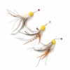 Three octopus cat toy lures arranged on white, showing varied natural feather patterns, long peacock herl strands, yellow bodies, and colored bells.