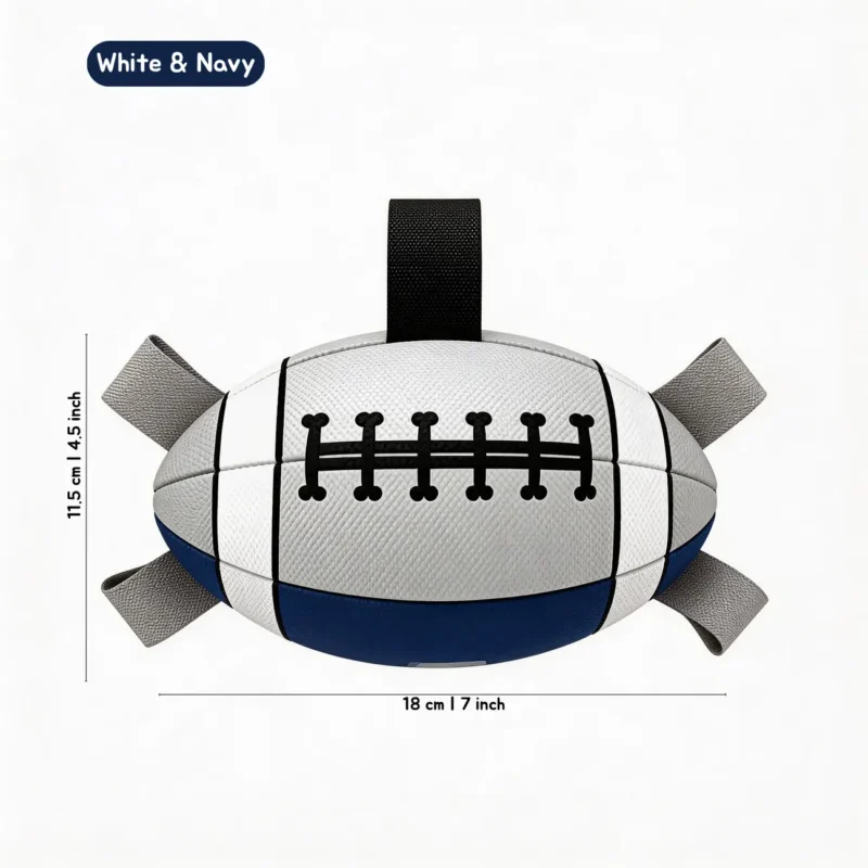 White and Navy Poolside Tug Football Floating Dog Toy with black and gray grab straps, navy panel, football lacing detail, and 18 x 11.5 cm size.
