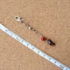 Red Fly cat teaser wand set lure with a small insect-inspired body and colorful details, designed for cat teasing games that encourage chasing and tracking.