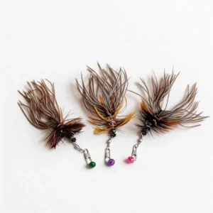 Three Shadow Bug Ostrich and Chicken Feather Cat Wand Replacement refills with natural layered feathers, metal clips, and colorful bells arranged on a white background.