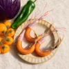 Handmade shrimp cat toy wand refill featuring orange mesh shell, feather tails, and iridescent whiskers inspired by a tiny river creature.