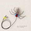 Spotted feather fly insect cat toy replacement showing soft feather wings, blue eyes, and small prey details for cat play.
