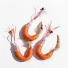 Three orange Wooly Shrimp Cat Wand Replacement refills on a white background, featuring pink shiny silk shrimp antennae, small bell clips, curved wool-filled bodies, and natural feather tails for interactive cat play.