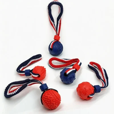 SportLoop Textured Tug Ball Dog Toy Collection SportLoop Textured Tug Ball Dog Toy collection with red and navy rubber chew balls and woven bungee tug handles