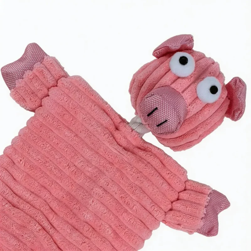 Close-up of Piggy Puff soft corduroy plush pig dog toy with textured fabric and cute snout