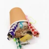 Top view of Kraft Snack Cup Shredding Bird Toy with cork bark, loofah, woven paper tubes, and chewable textures