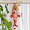 Red Sundae Shred Cone Foraging and Chew Toy for small to medium parrots, featuring paper shred, rattan cone, chew balls, wood stars, and bell