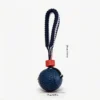 Navy Tire Tread SportLoop Textured Tug Ball Dog Toy with grippy rubber ball and navy woven tug loop, 7 cm by 29 cm