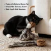 Black and white cat hugging and biting a Bunny Fur Octopus Cat Kicker Toy for scent enrichment and solo kick play.