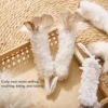Curly wool kitty kicker toy with natural feathers designed for cats to grab, wrestle, and kick