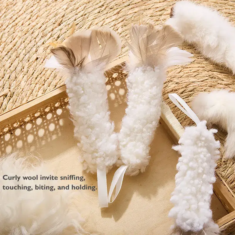Curly wool kitty kicker toy with natural feathers designed for cats to grab, wrestle, and kick