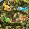 four-bird-designs-chirping-cat-toy-outdoor-display Four colorful bird designs of a chirping cat toy displayed on a tree branch.