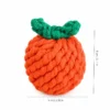 Orange fruit-shaped cotton rope dog toy with green leaves, measuring about 8 x 6 cm for indoor fetch and carrying.