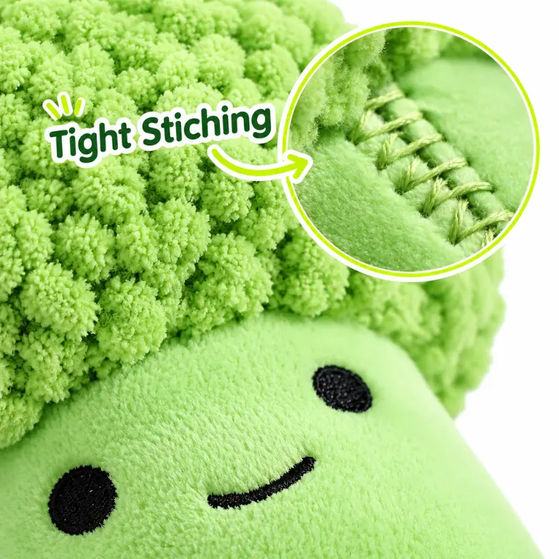 broccoli-plush-tight-stitching-detail Close-up of the broccoli plush toy's bobble fleece crown and tight stitching beside its embroidered smile.