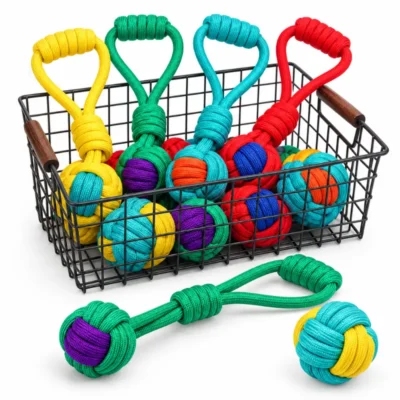 Collection of colorful rope ball dog toys and tug ropes featuring braided knot balls and loop handles, showing multiple color options for interactive dog play.