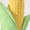 corn-plush-dog-toy-corduroy-texture Close-up of a corduroy plush toy for dogs, showing the ribbed texture of the golden corn cob and soft green husks.