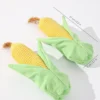 corn-plush-toy-size-guide Two corn plush toys for dogs shown with measurement lines indicating a length of 21 cm and a width of 7 cm.