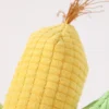 corn-vegetable-plush-tassel-detail Close-up of a golden corn cob and fine golden-orange tassel on a vegetable plush dog toy, with textured fabric resembling fresh corn kernels.