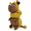 A giraffe stuffed animal with its long neck curled around its body, showing the textured mustard-yellow and brown fabric and short legs.