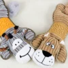 Close-up of the gray donkey and tan dog, two cuddly stuffed animals with corduroy plush bodies, floppy ears, and embroidered smiles.