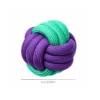green-purple-braided-rope-ball-dog-toy Green and purple braided rope dog toy featuring a round rope knot ball, giving dogs a textured surface for biting, carrying, and interactive play.